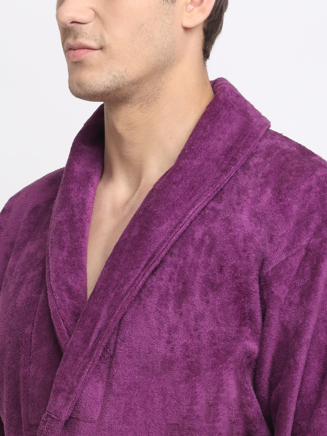 Close-up of a man wearing a purple cotton bathrobe with a tie belt