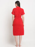 Back view of a woman wearing a red micro terry bathrobe with a tie belt