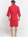 A man wearing a red bathrobe, shown from the back against a plain white studio background.