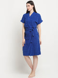 A Woman wearing a royal blue micro terry bathrobe with a tie belt