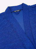 Close-up of a royal blue micro terry bathrobe showing the collar and fabric texture
