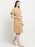 Woman wearing a rust micro terry bathrobe with a tie belt