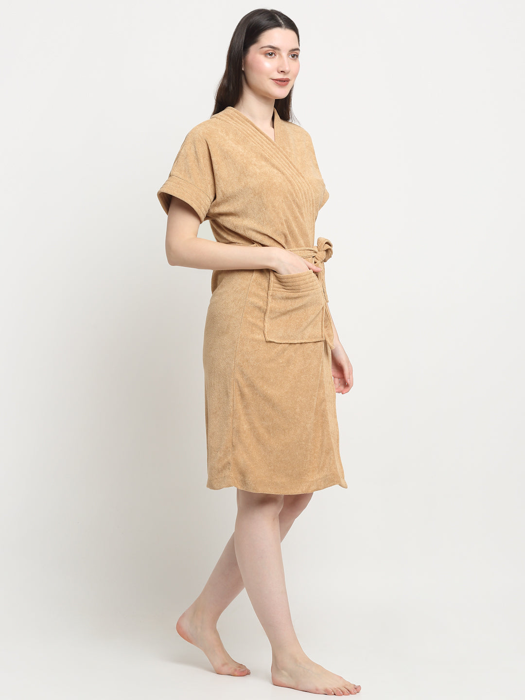 Woman wearing a rust micro terry bathrobe with a tie belt