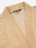 Close-up of a rust micro terry bathrobe showing the collar and fabric texture
