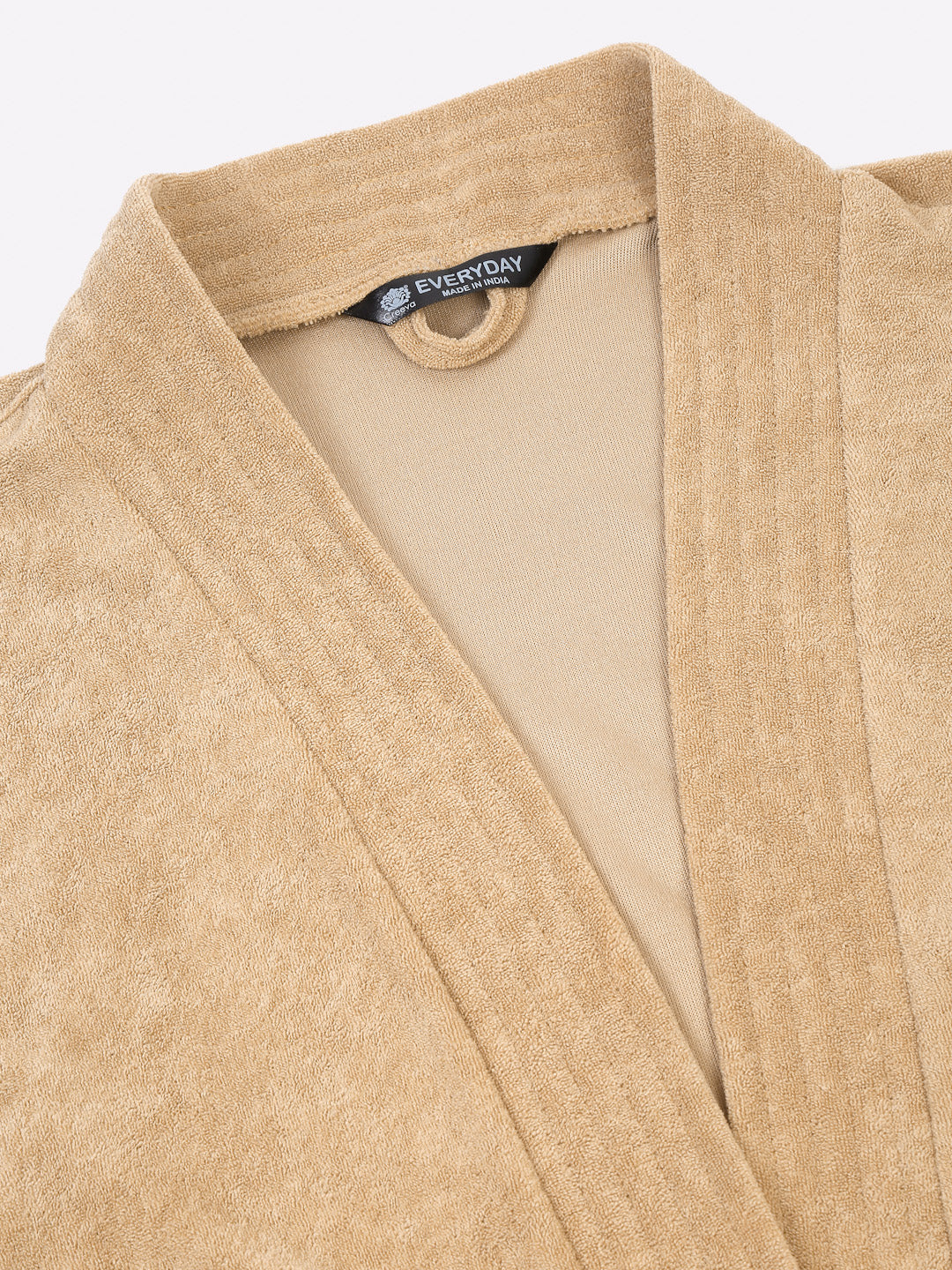 Close-up of a rust micro terry bathrobe showing the collar and fabric texture