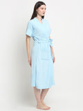 A woman wearing a sky-blue micro terry bathrobe with a tie belt