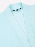 Close-up of a sky blue micro terry bathrobe showing the collar and fabric texture