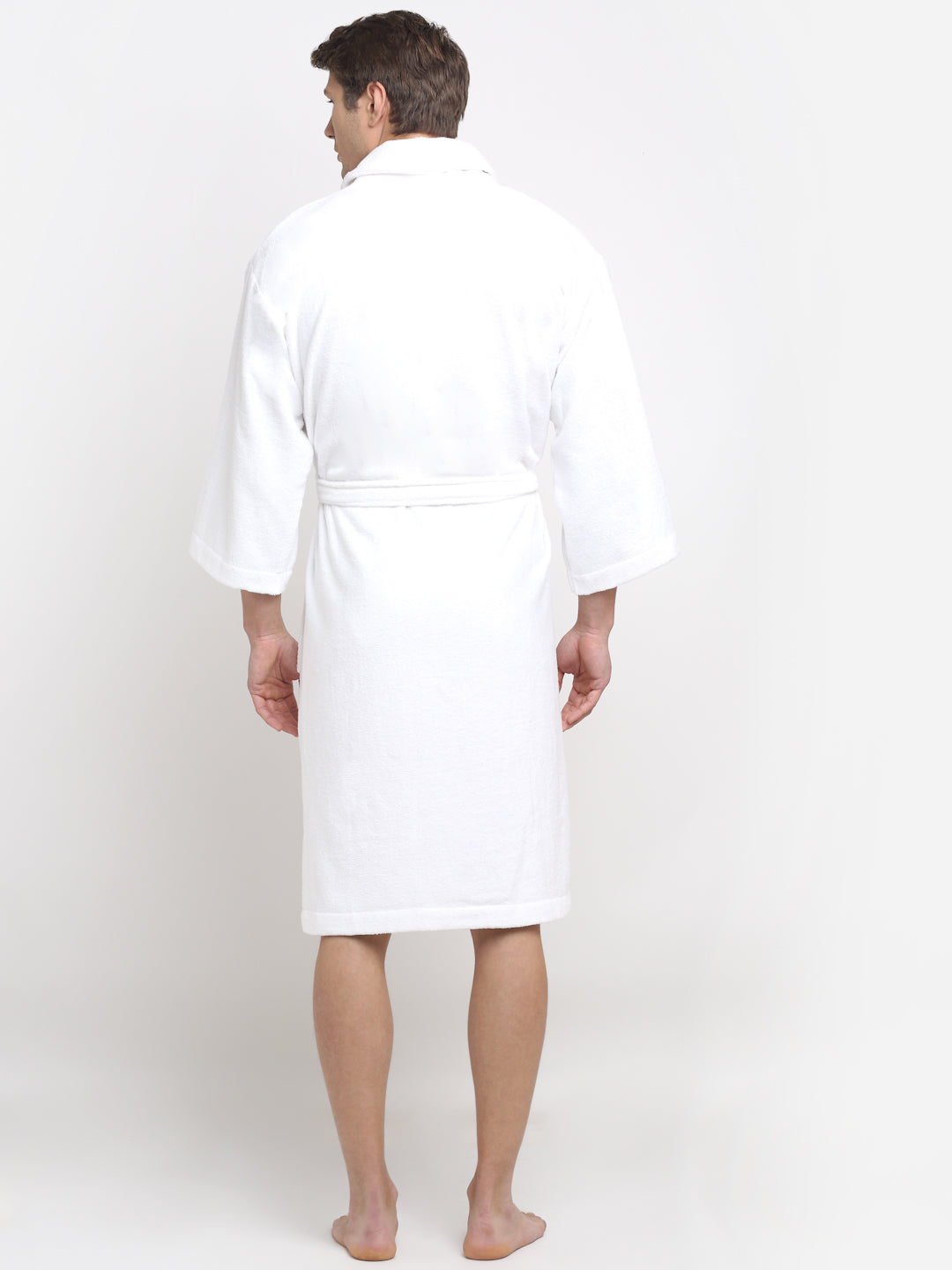Back view of a man wearing a white cotton bathrobe with a tie belt