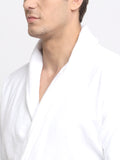 Close-up of a man wearing a white cotton bathrobe with a tie belt