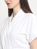 Close-up of a woman wearing a white micro terry bathrobe with a tie belt