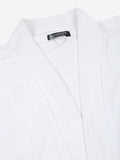 Close-up of a white micro terry bathrobe showing the collar and fabric texture