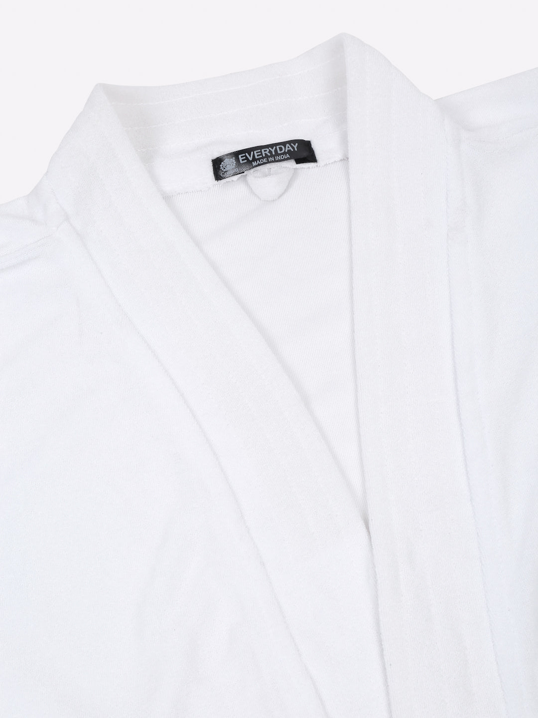 Close-up of a white micro terry bathrobe showing the collar and fabric texture