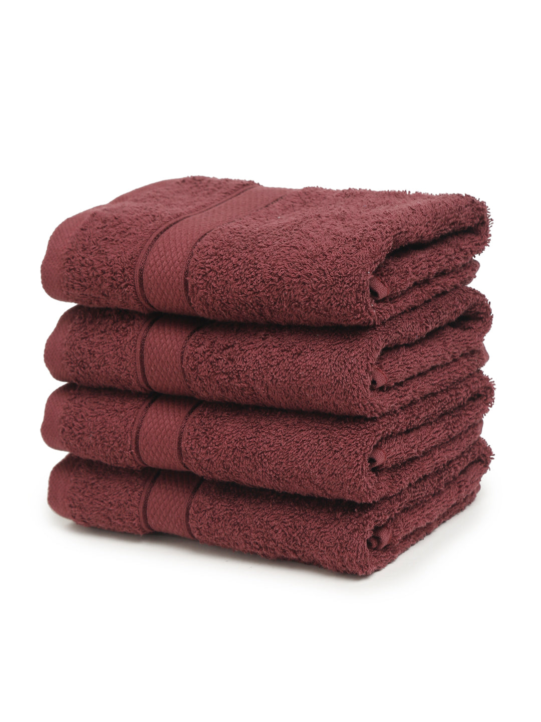A set of Wine Creeva brand hand towels stacked on a bathroom counter, with a wooden backdrop and a white background.