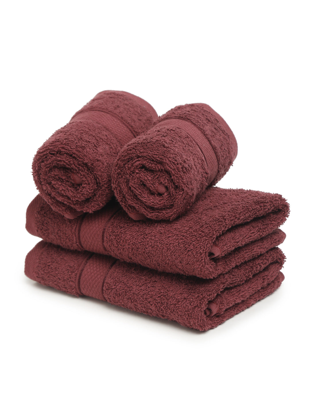 A set of four wine Creeva brand hand towels stacked on a bathroom counter, with a wooden backdrop and a white background.