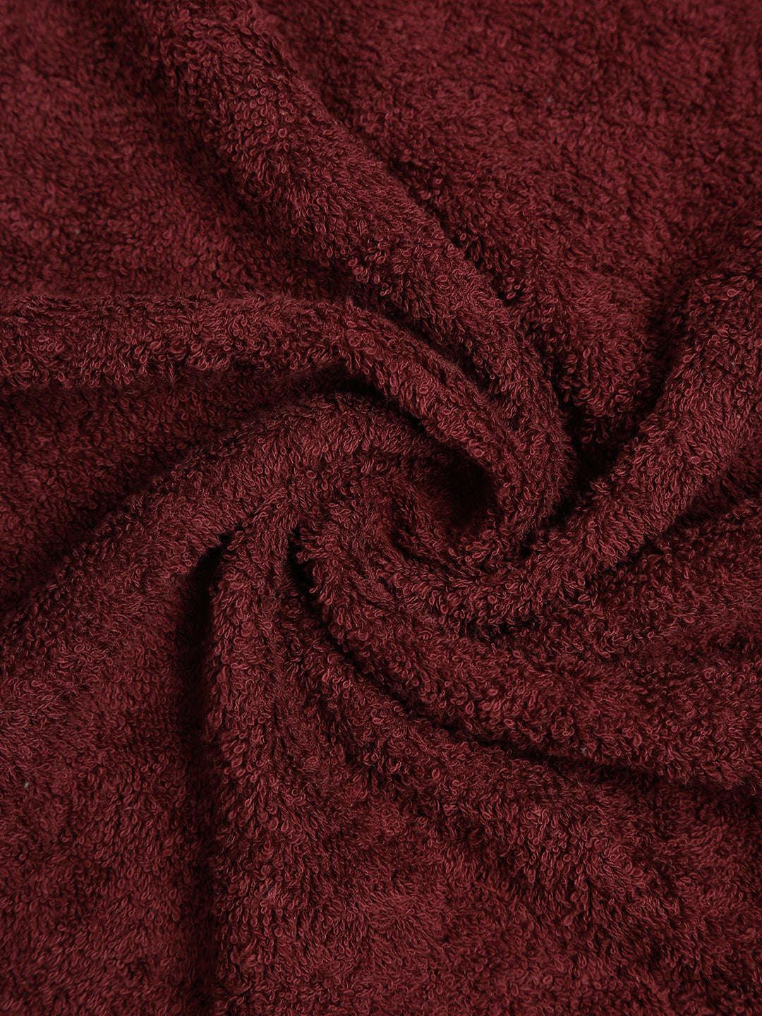 Wine cotton hand towel with a soft textured terry fabric surface.