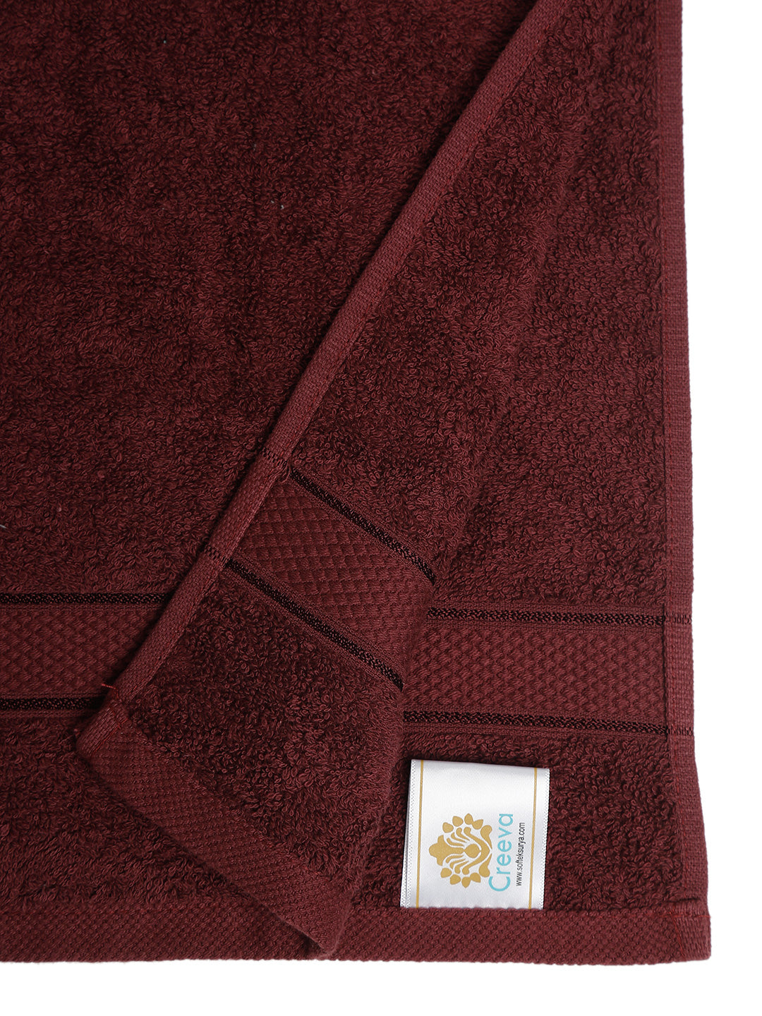 Wine cotton hand towel showing a close-up of the terry texture, decorative stripe detailing, and CREEVA label.