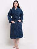 A person standing in a blue cotton bathrobe with a relaxed fit.