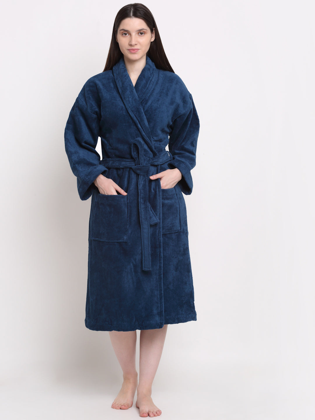 A person standing in a blue cotton bathrobe with a relaxed fit.
