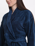 Close-up of a woman wearing a navy blue cotton bathrobe with a shawl collar and waist belt