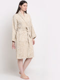 A Woman wearing a cream and rust 100% cotton bathrobe with a waist belt and front pockets