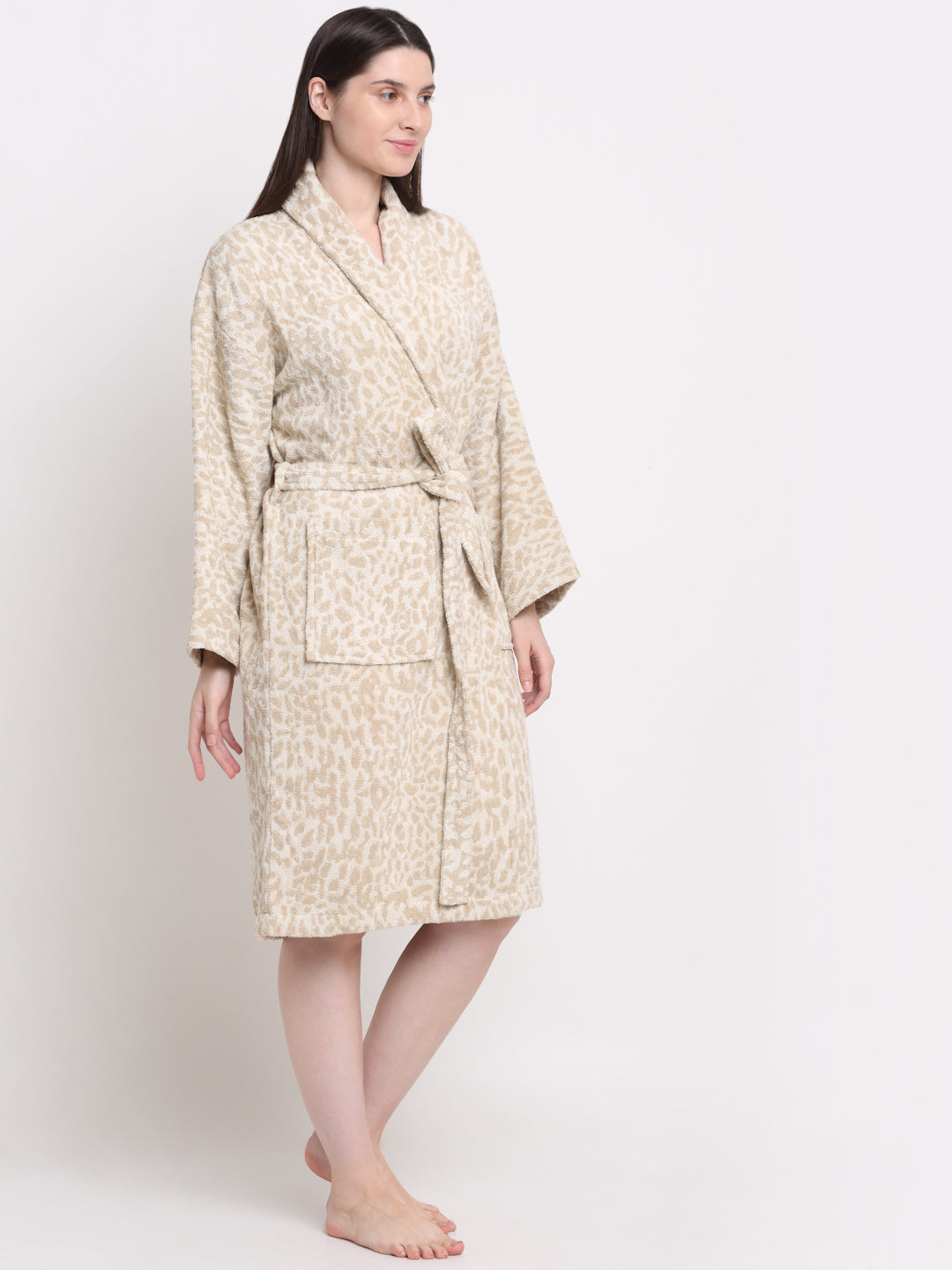A Woman wearing a cream and rust 100% cotton bathrobe with a waist belt and front pockets