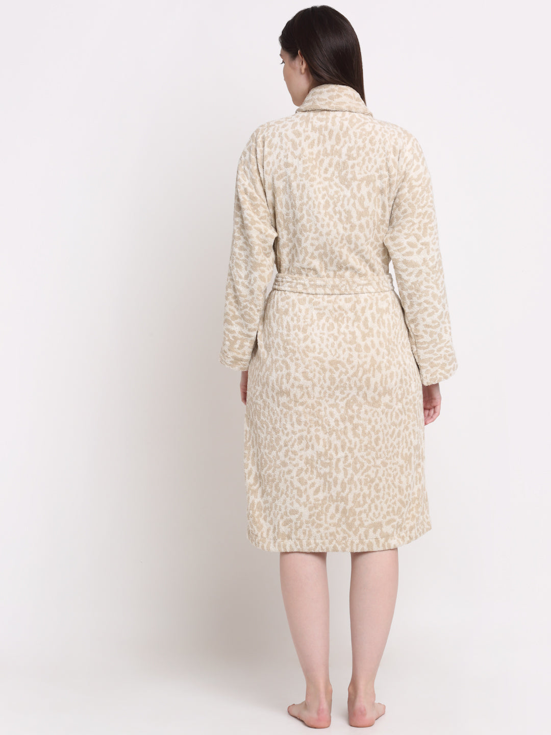 Back view of a woman wearing a cream and rust cotton bathrobe with a waist belt