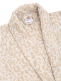Close-up of a cream and rust cotton bathrobe showing the shawl collar, soft terry texture, and CREEVA label
