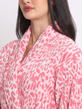 Close-up of a woman wearing a pink leopard bathrobe with a shawl collar and waist belt
