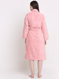 Back view of a woman wearing a pink bathrobe with a waist belt