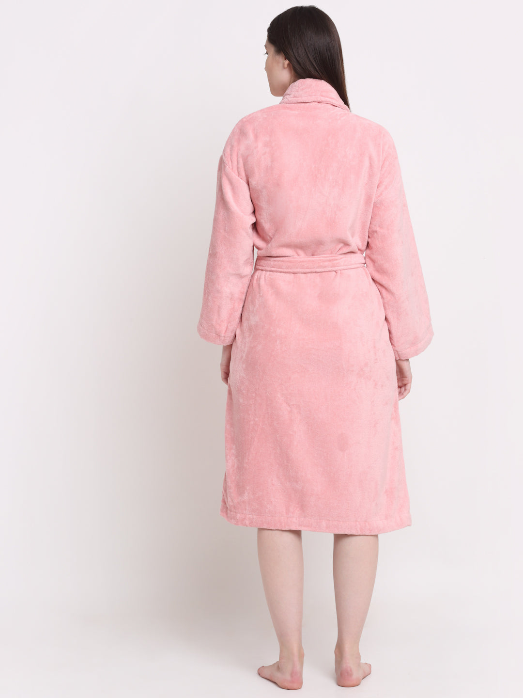 Back view of a woman wearing a pink bathrobe with a waist belt