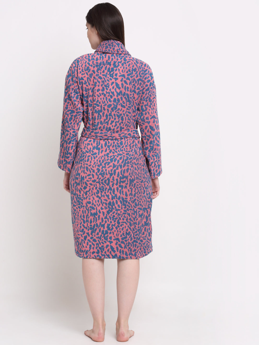 Back view of a woman wearing a pink-blue bathrobe with a waist belt