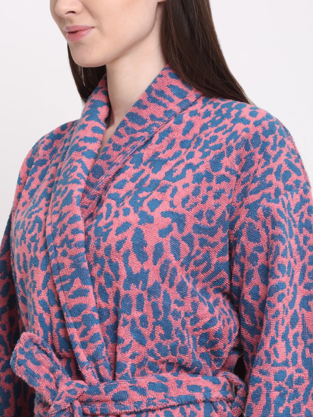 Close-up of a woman wearing a pink-blue bathrobe with a shawl collar and waist belt