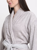 Close-up of a woman wearing a silver cotton bathrobe with a shawl collar and waist belt