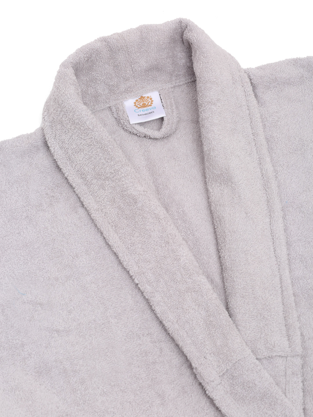 Close-up of a silver cotton bathrobe showing the shawl collar, soft terry texture, and CREEVA label