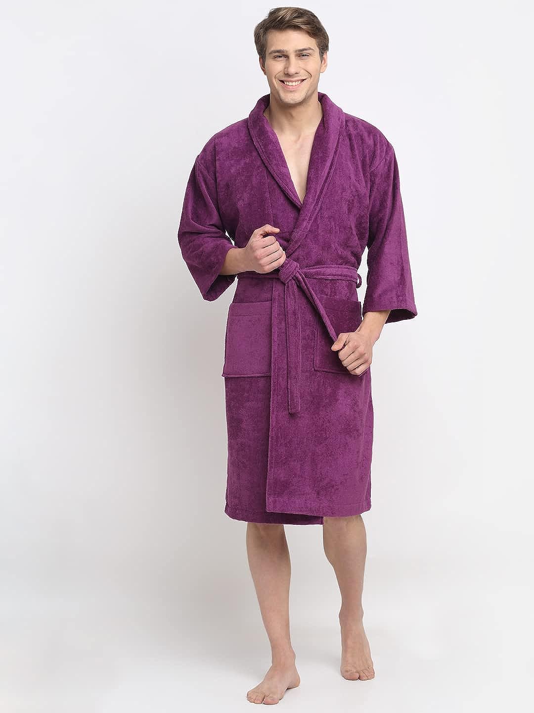 A person standing and smiling, wearing a purple 100% cotton unisex bathrobe.