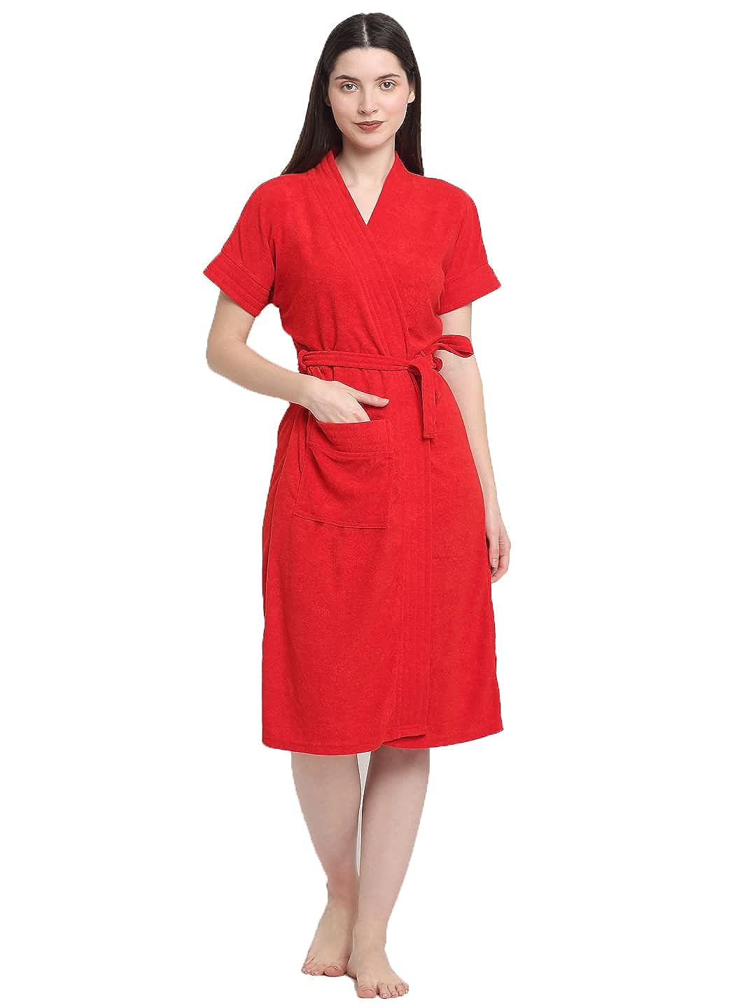 A woman standing and wearing a bold red terry bathrobe with a V-neck and long sleeves.